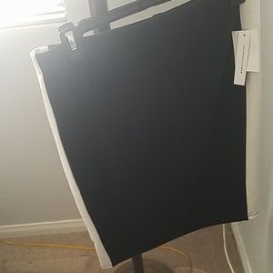 Black pencil skirt with white fabric on each side.